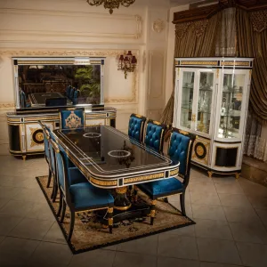 Luxury Dining Room featuring the BLU Louis XV Dining room in solid wood with 24-karat Gold gilded accents. The table, chairs, and China are all present and captured at an angle.