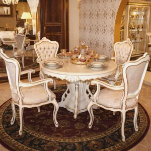 Luxurious dining room photo of the Suzette Victorian Dinette in pearl with decorated colors. Features the table and 4 chairs with accessories on the table from a corner angle.