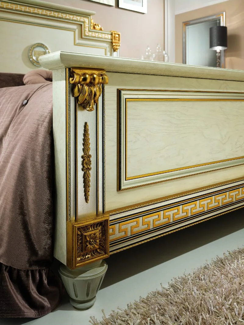 Footboard detail from the Gianni 24-Karat Gold Collection with gold trim and lacquer finish.