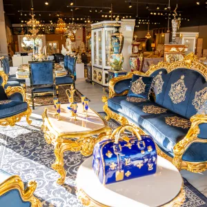Corner angle photo of the Blu Louis XV LIving Room in 24-karat gold leaf and Blue Velvet featuring the sofa and chair.